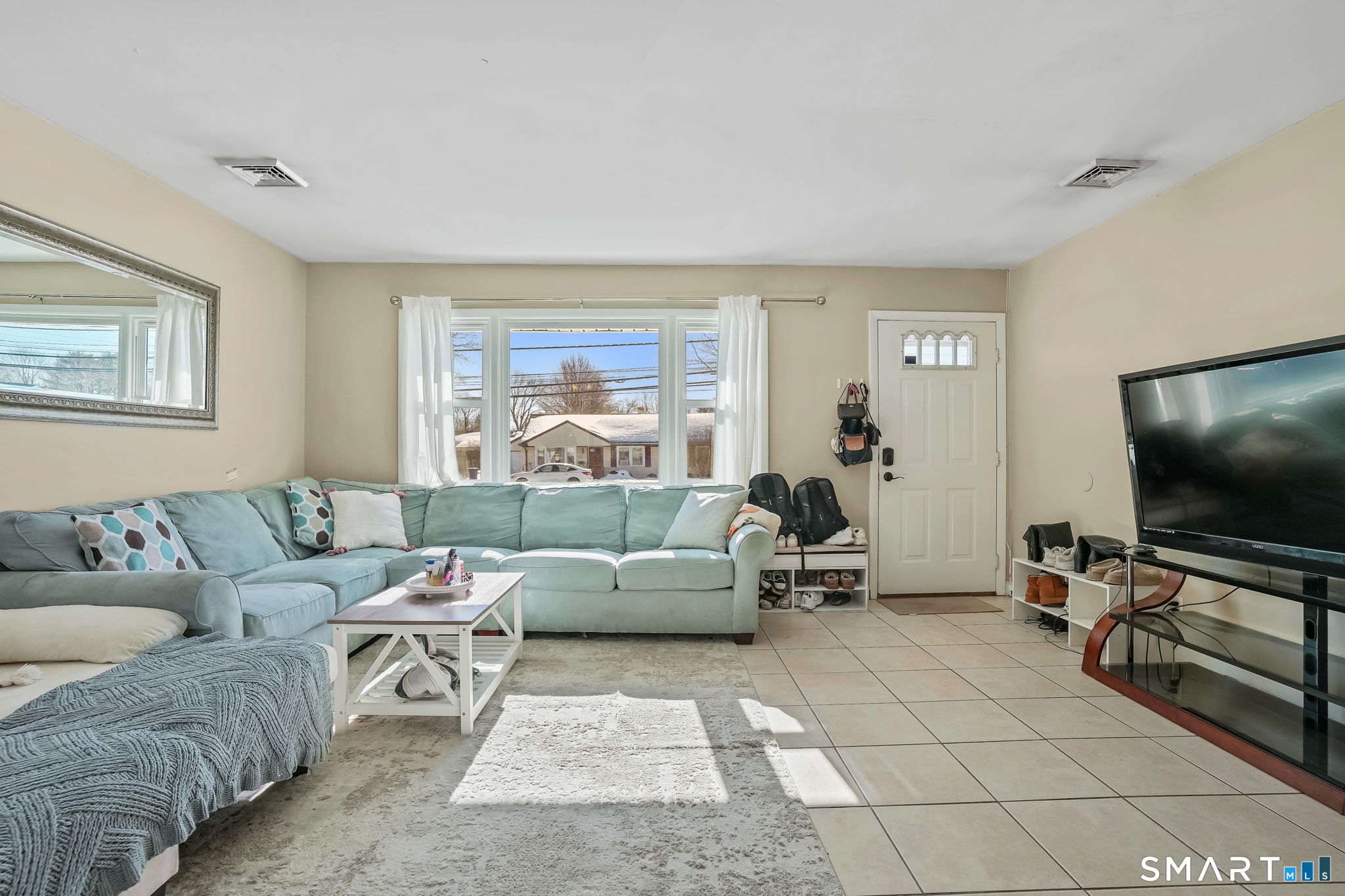 3460 Old Town Road Bridgeport, CT 06606 - Photo 5 of 34 a living room with furniture and a flat screen tv
