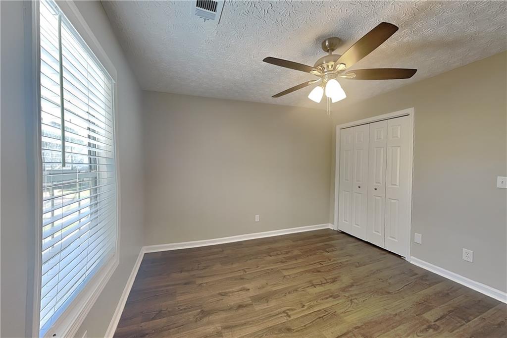 2730 Jona Trail Dacula, GA 30019 - Photo 11 of 19 a view of an empty room with wooden floor and a window