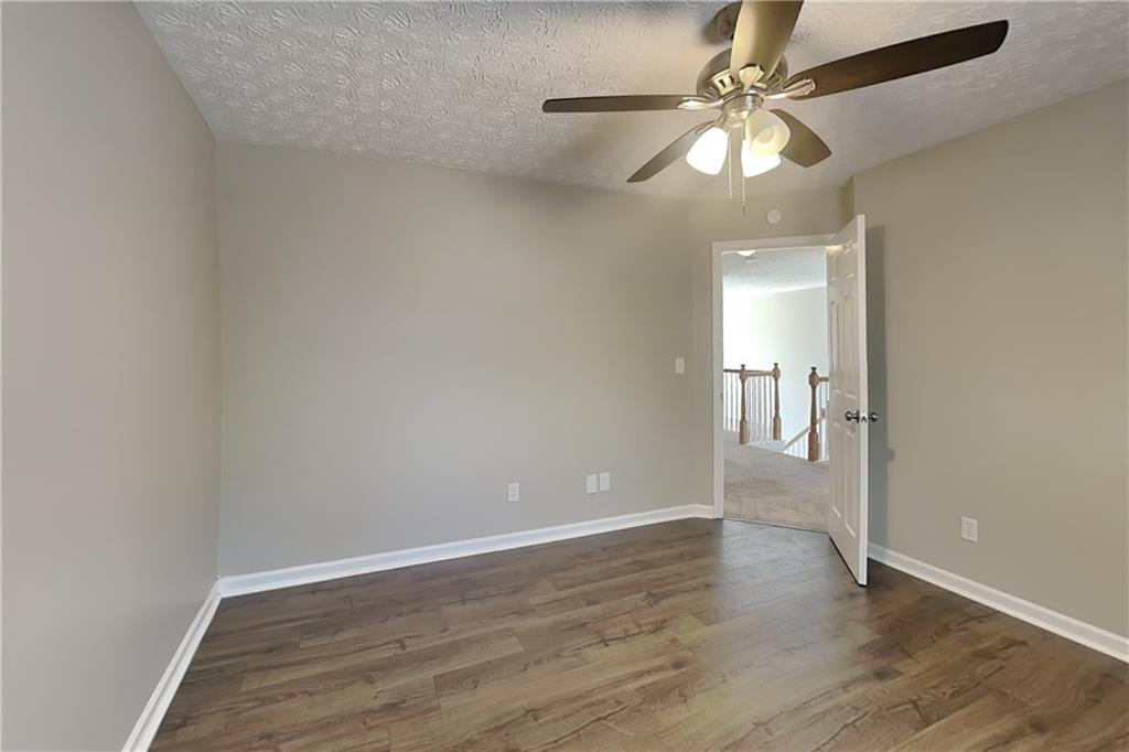2730 Jona Trail Dacula, GA 30019 - Photo 13 of 19 wooden floor in an empty room with a window