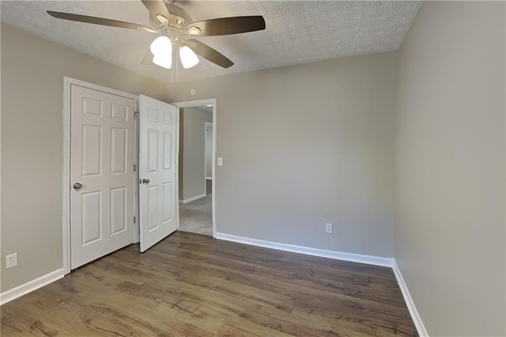 2730 Jona Trail Dacula, GA 30019 - Photo 14 of 19 an empty room with wooden floor fan and window