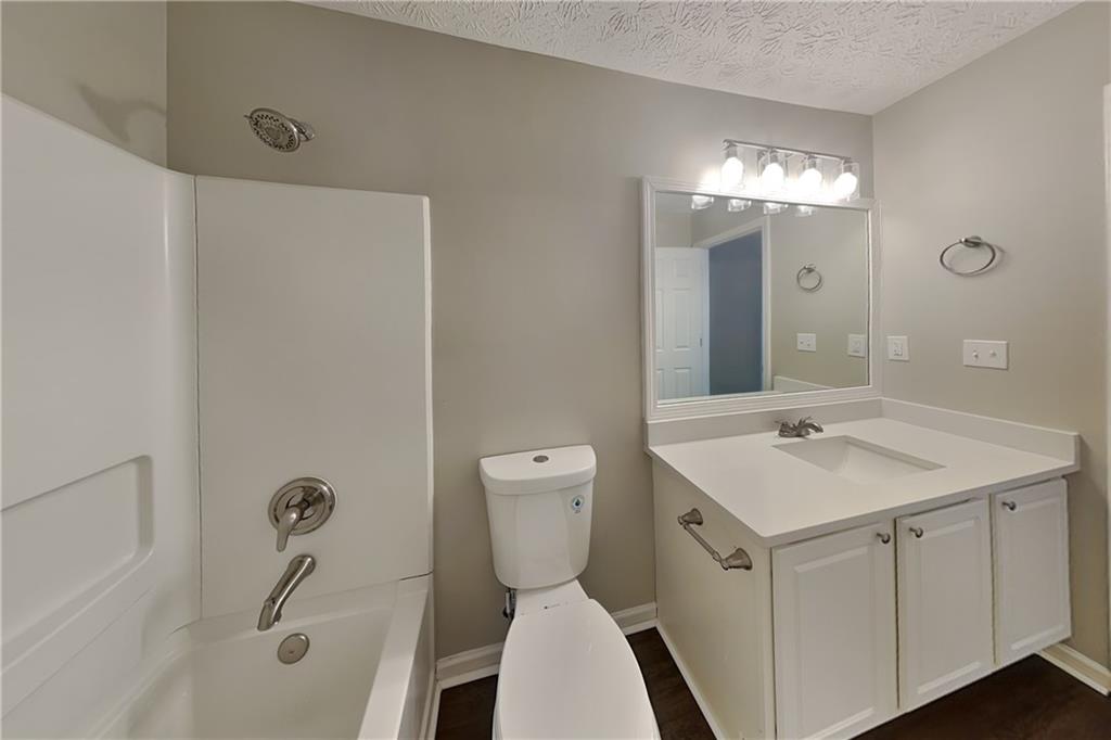 2730 Jona Trail Dacula, GA 30019 - Photo 16 of 19 a bathroom with a sink a toilet and shower