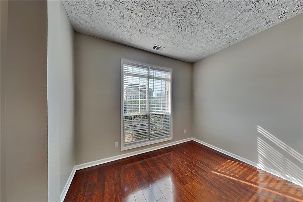 2730 Jona Trail Dacula, GA 30019 - Photo 2 of 19 a view of an empty room with wooden floor and a window