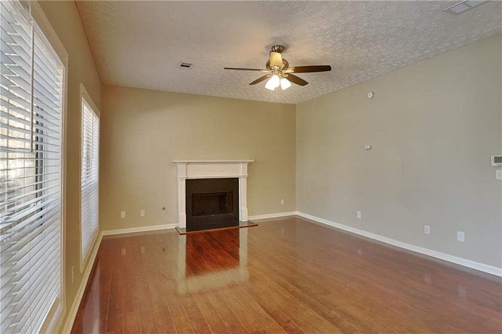 2730 Jona Trail Dacula, GA 30019 - Photo 3 of 19 a view of empty room with wooden floor and fan