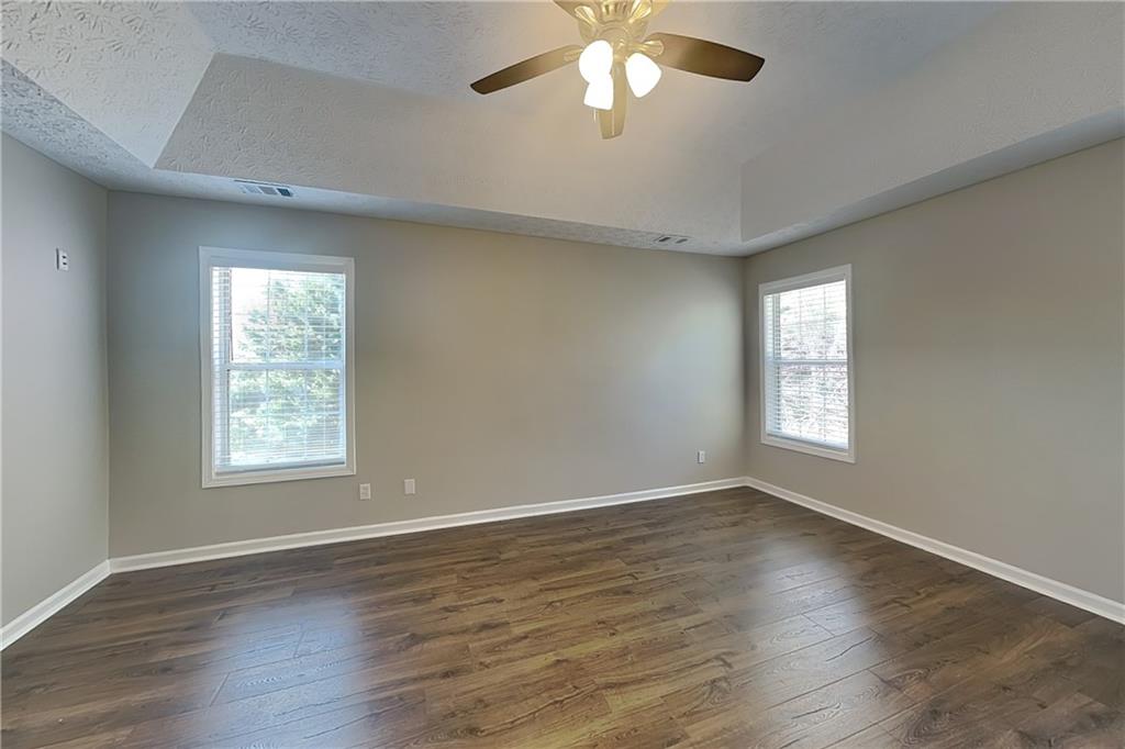 2730 Jona Trail Dacula, GA 30019 - Photo 6 of 19 a view of an empty room with wooden floor and a window