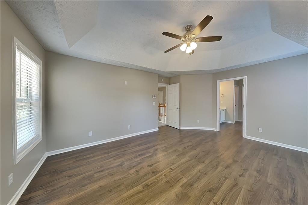 2730 Jona Trail Dacula, GA 30019 - Photo 7 of 19 a view of an empty room with wooden floor and a window
