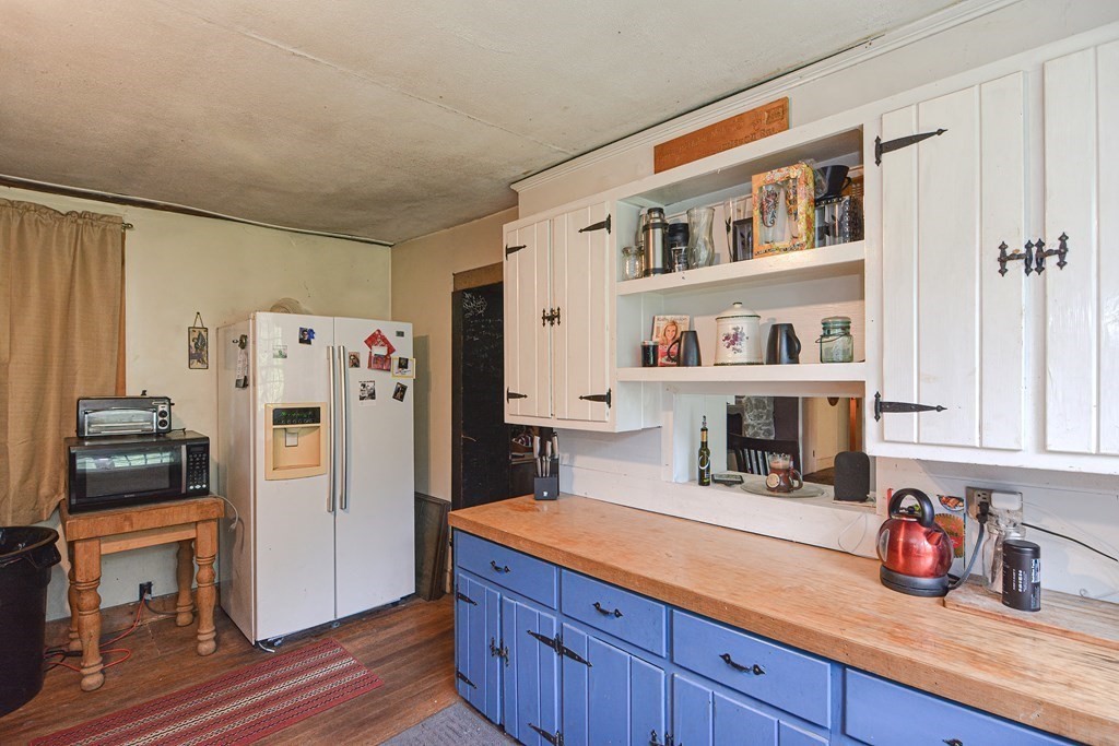 215 Burlingame Road Palmer, MA 01069 - Photo 11 of 41 a kitchen with granite countertop a refrigerator and a stove top oven