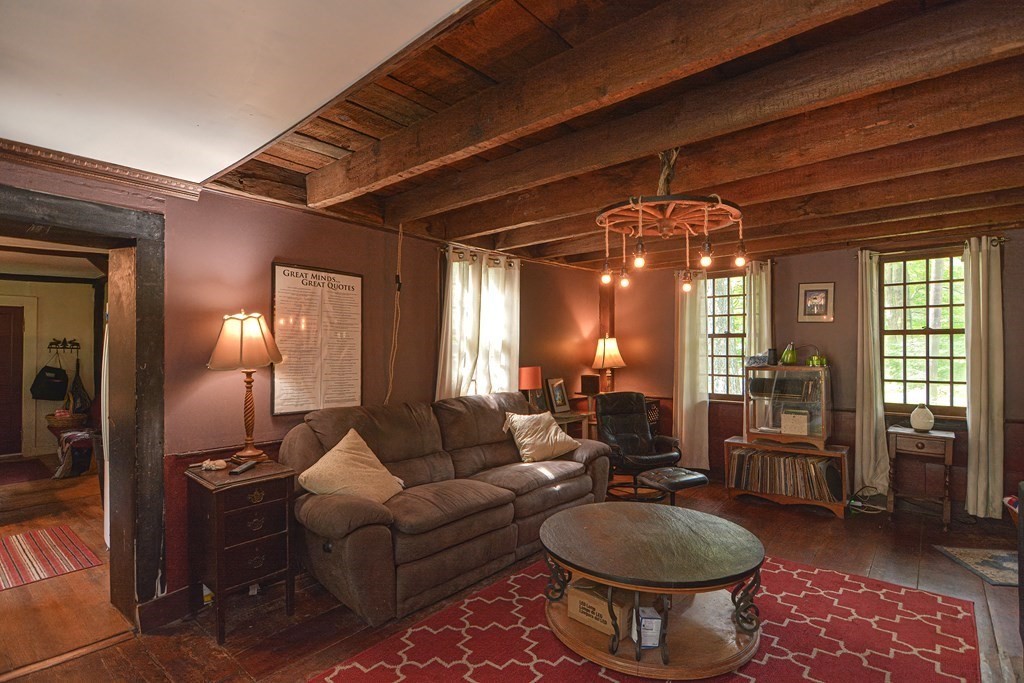 215 Burlingame Road Palmer, MA 01069 - Photo 14 of 41 a living room with furniture a lamp and a large window