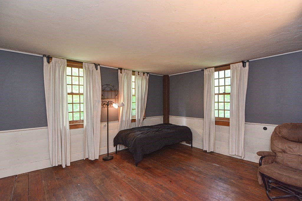 215 Burlingame Road Palmer, MA 01069 - Photo 20 of 41 a bedroom with a bed and wooden floor