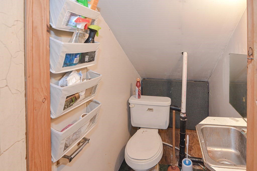 215 Burlingame Road Palmer, MA 01069 - Photo 29 of 41 a white toilet sitting next to a bathroom sink