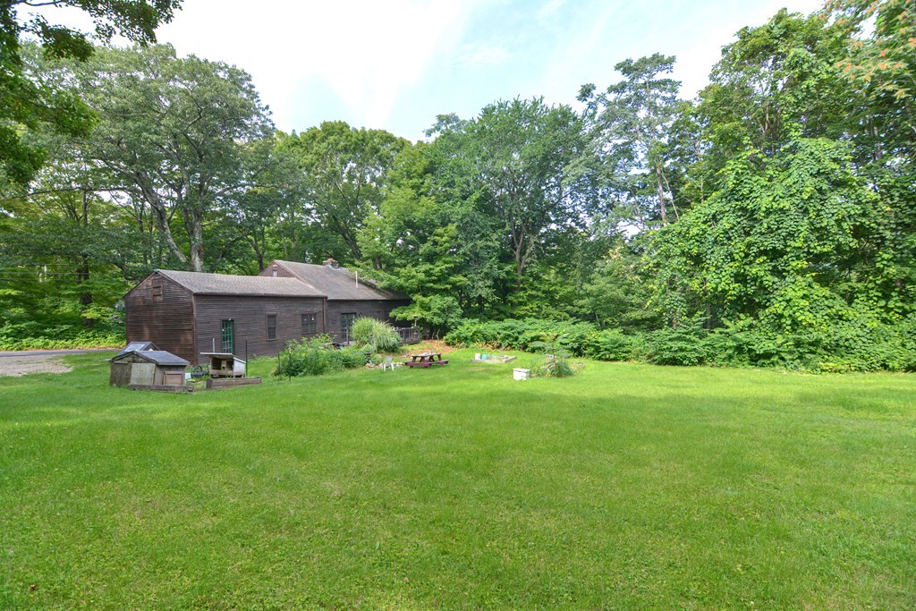 215 Burlingame Road Palmer, MA 01069 - Photo 41 of 41 a view of a backyard with wooden fence and a bench