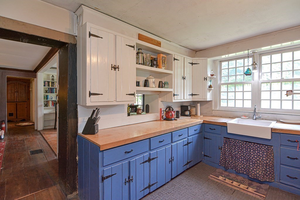 215 Burlingame Road Palmer, MA 01069 - Photo 9 of 41 a kitchen with a sink stove and cabinets