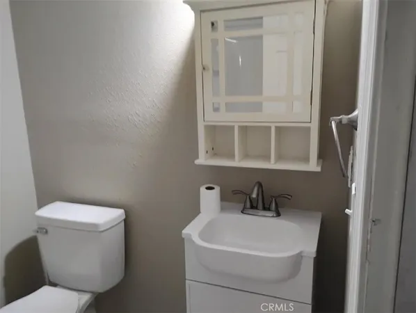 a white toilet sitting next to a bathroom sink