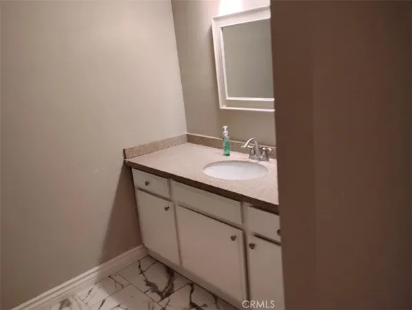 a bathroom with a sink a vanity and a mirror