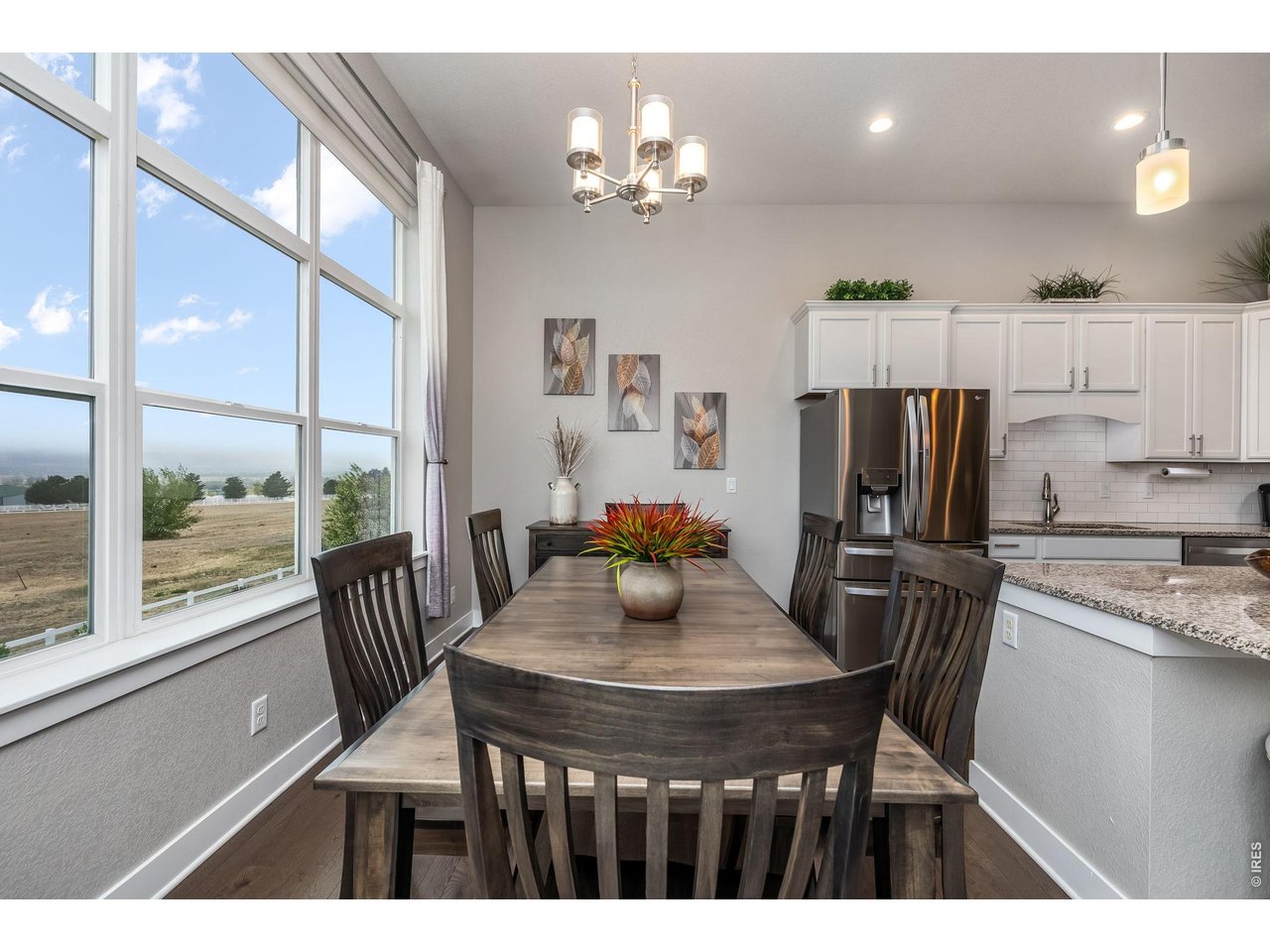3789 Bridle Ridge Circle Severance, CO 80524 - Photo 17 of 44 a view of a dining room with furniture a chandelier and wooden floor