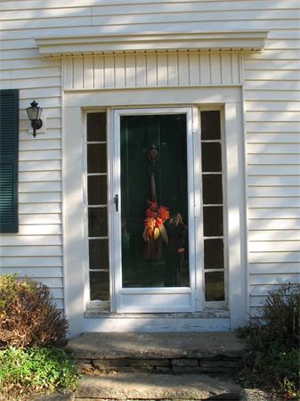 137 Hadley Road Sunderland, MA 01375 - Photo 2 of 30 a front view of a house with a yard and garage