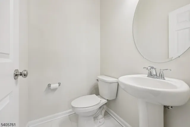 a bathroom with a sink toilet and a mirror