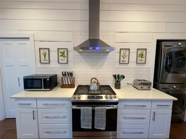 a kitchen with a stove and cabinets