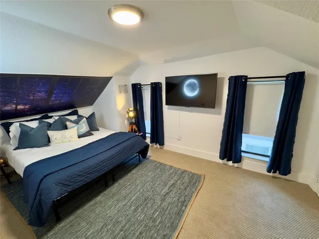 a bedroom with a bed and a mirror