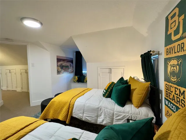 a bedroom with a bed and painting on the wall