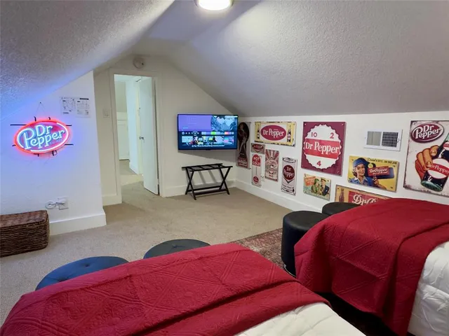 a bedroom with two beds and a painting on the wall
