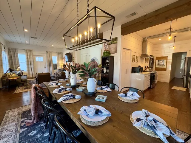 a open dining room with furniture and wooden floor