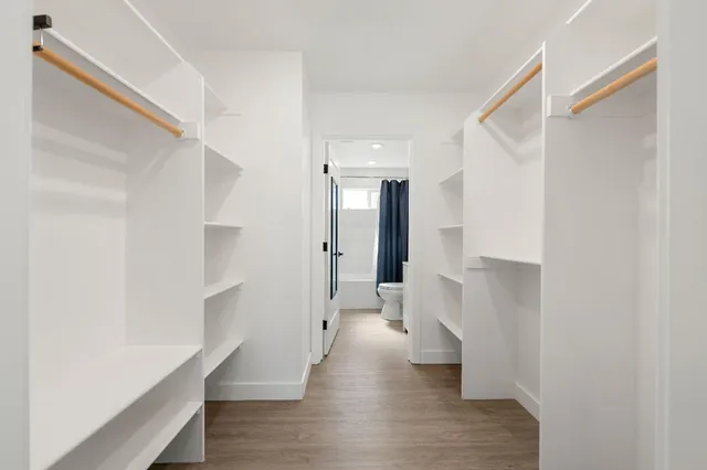 a bathroom with a toilet sink vanity tub and mirror