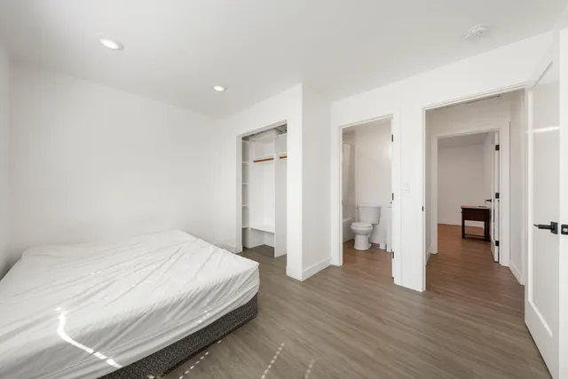 a white toilet sitting next to a white tub