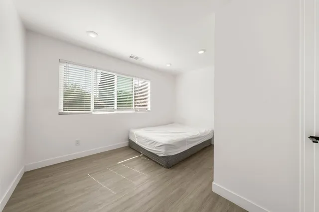 a bedroom with a bed and a desk