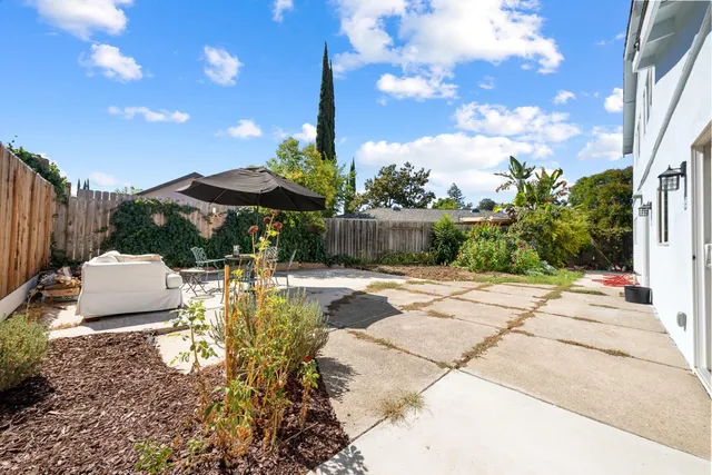 a view of backyard with a patio and outdoor seating