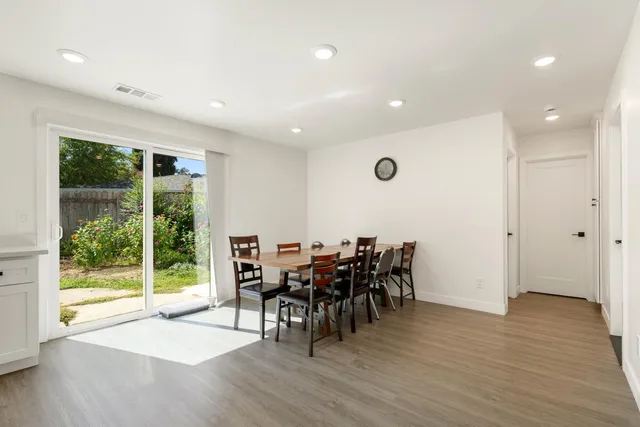 a kitchen with granite countertop white cabinets and stainless steel appliances