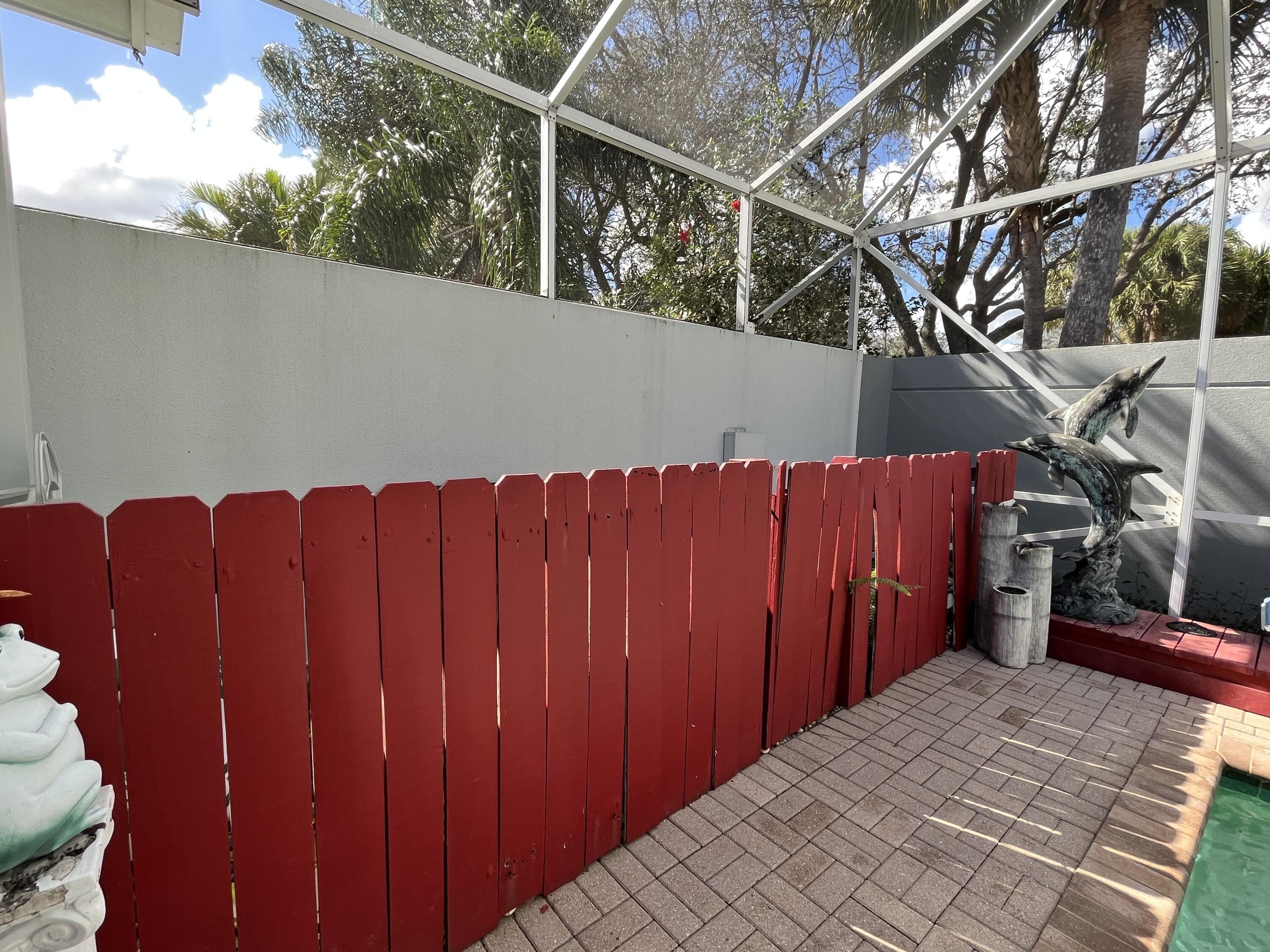 206 South Hampton Drive Jupiter, FL 33458 - Photo 23 of 24 a view of a house with wooden fence