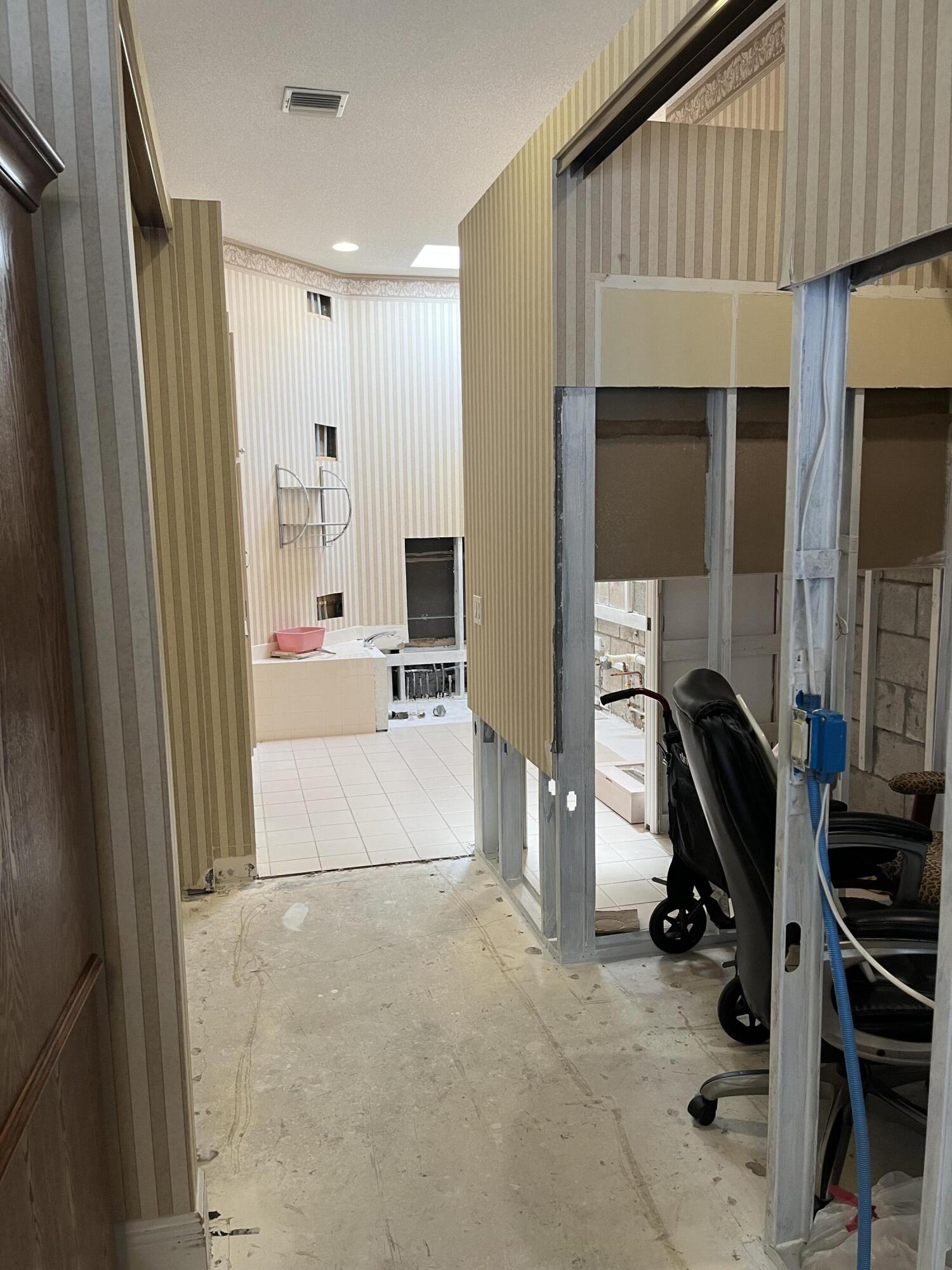 206 South Hampton Drive Jupiter, FL 33458 - Photo 6 of 24 a view of a hallway with workspace and a window