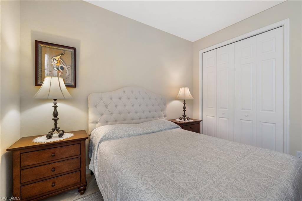 28529 Westmeath Court Bonita Springs, FL 34135 - Photo 17 of 49 a bedroom with a bed and lamp