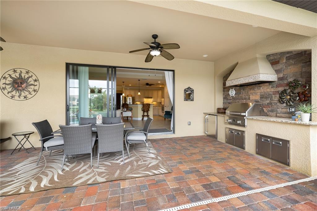 28529 Westmeath Court Bonita Springs, FL 34135 - Photo 21 of 49 a living room with a couch piano table and a stove