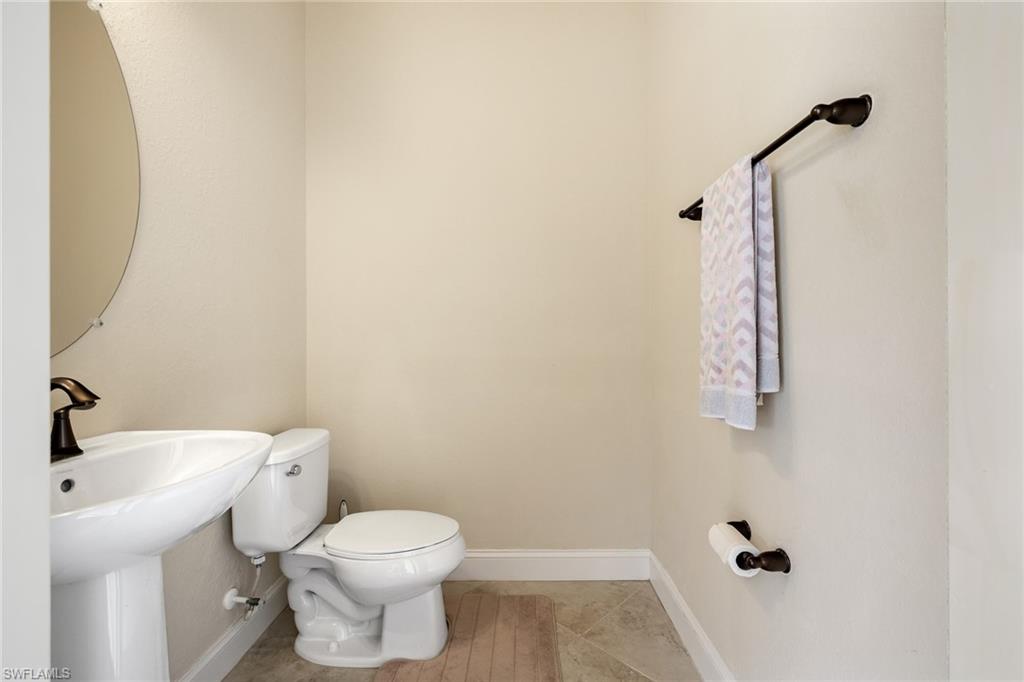 28529 Westmeath Court Bonita Springs, FL 34135 - Photo 25 of 49 a bathroom with a toilet sink and mirror