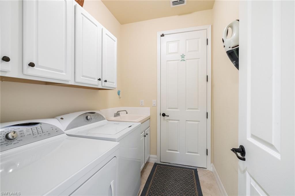 28529 Westmeath Court Bonita Springs, FL 34135 - Photo 26 of 49 a view of storage and utility room with a washer dryer