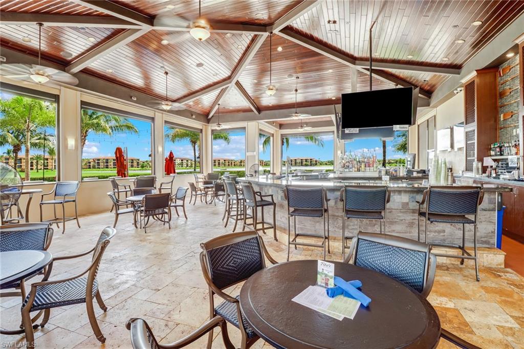 28529 Westmeath Court Bonita Springs, FL 34135 - Photo 46 of 49 a kitchen with stainless steel appliances kitchen island granite countertop a table and chairs