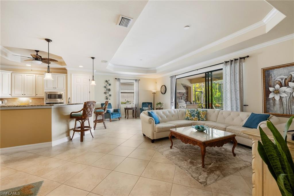 28529 Westmeath Court Bonita Springs, FL 34135 - Photo 9 of 49 a living room with lots of furniture and a view of kitchen