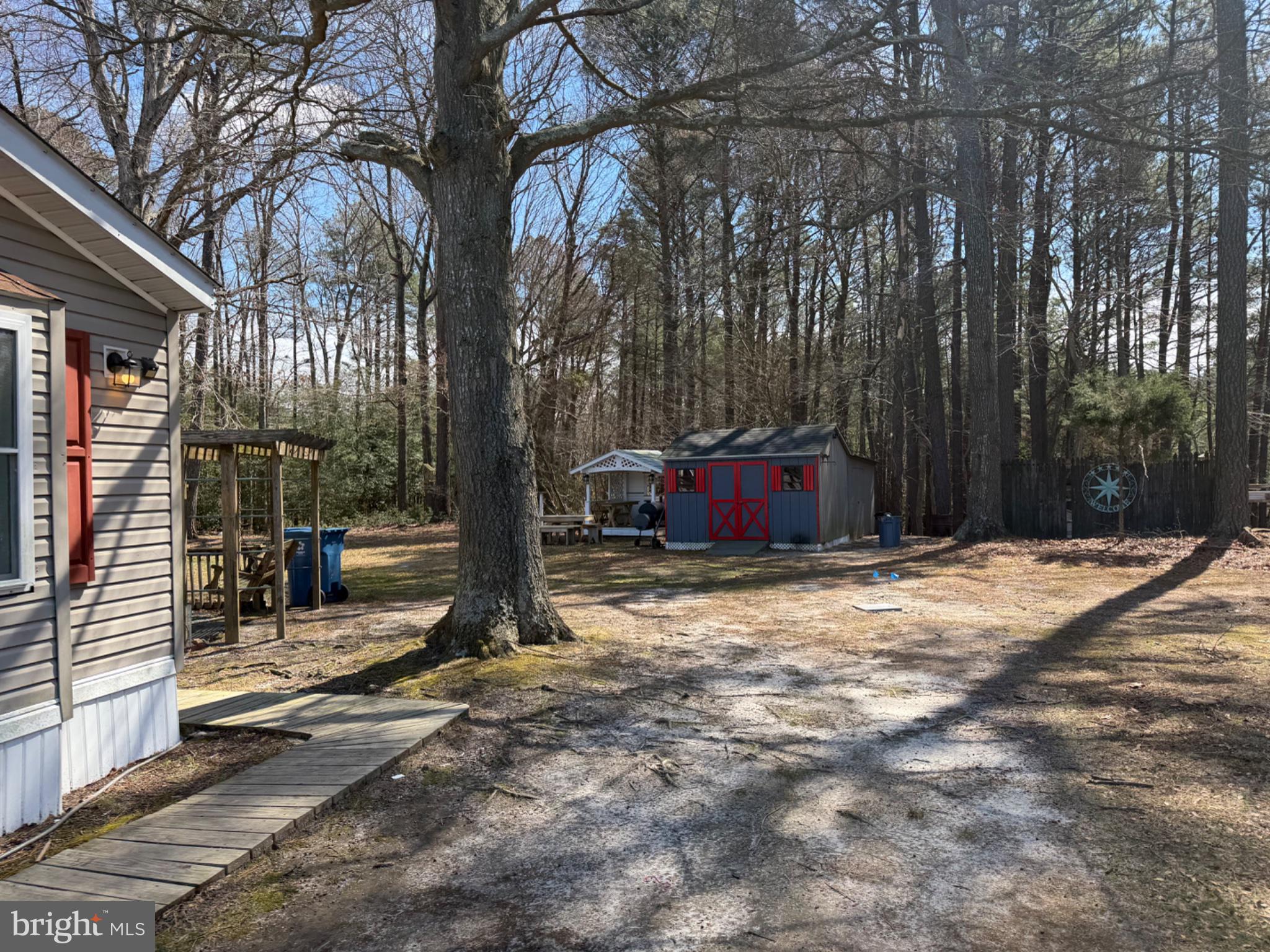 5799 Homestead Street Salisbury, MD 21801 - Photo 2 of 6 a backyard of a house with barbeque oven and trees