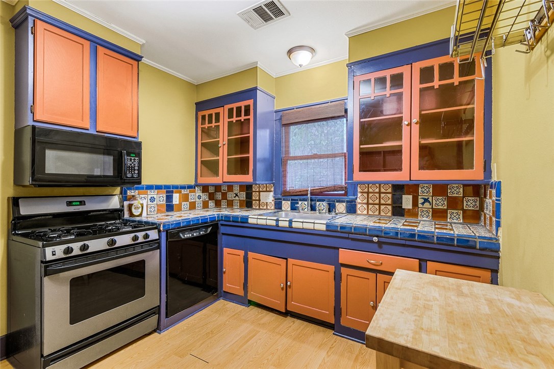 a kitchen with stainless steel appliances a stove and a microwave
