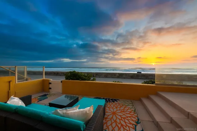 a living room with furniture kitchen view and a large window