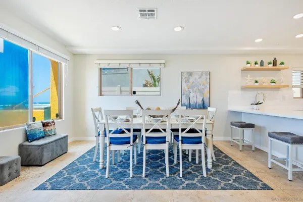 a dining room with furniture and wooden floor