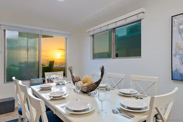 a living room with lots of furniture and view of kitchen