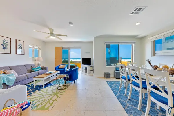a living room with furniture kitchen view and a window