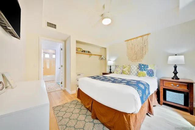 a bedroom with two beds and a dresser