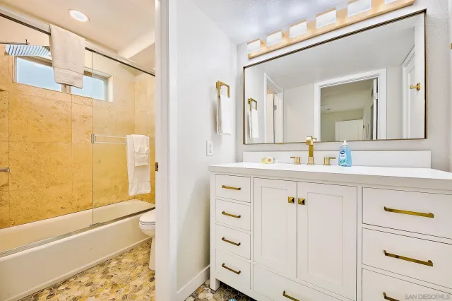 a bedroom with two beds and painting on the wall