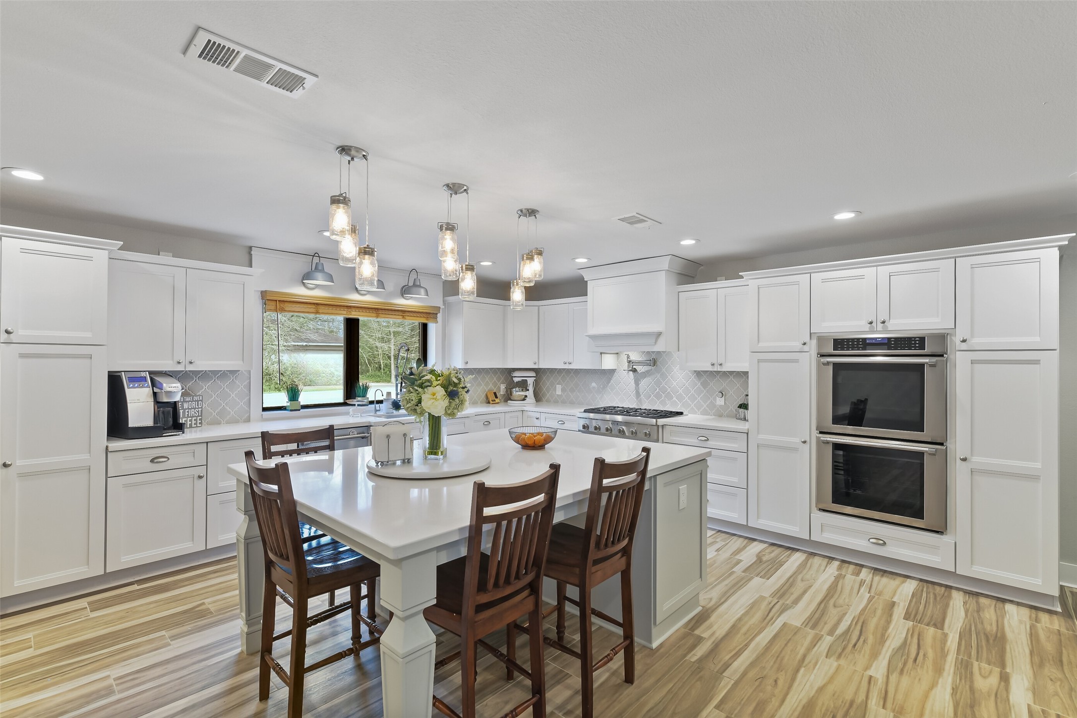This kitchen is every chef's dream and boasts quartz countertops, designer backsplash, Thermador appliances, high end custom cabinetry, centered around a 7-foot island with seating for five!