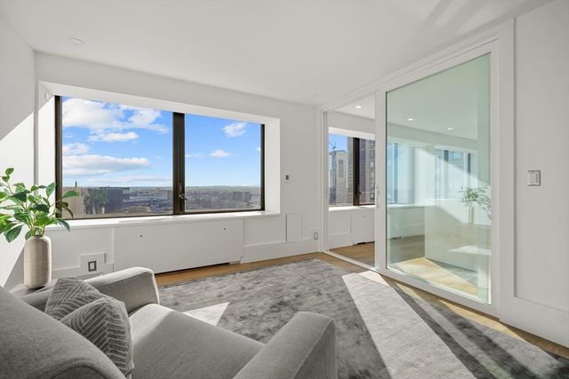 a living room filled with furniture and a large window