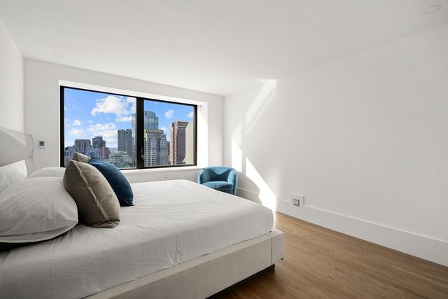 a bedroom with a large bed and a large window