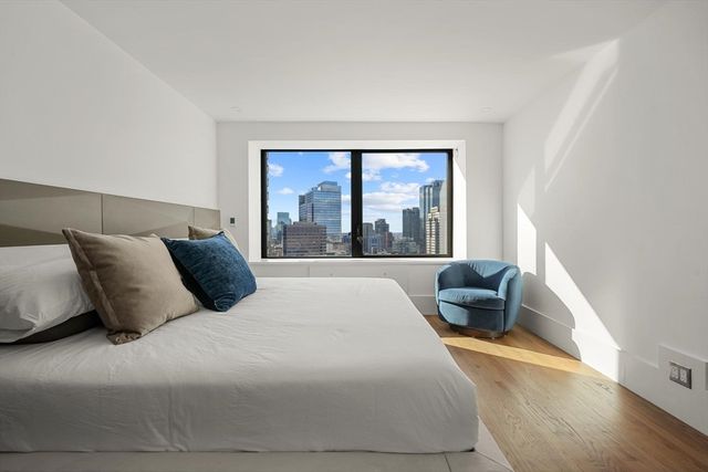 a bedroom with a large bed and a large window